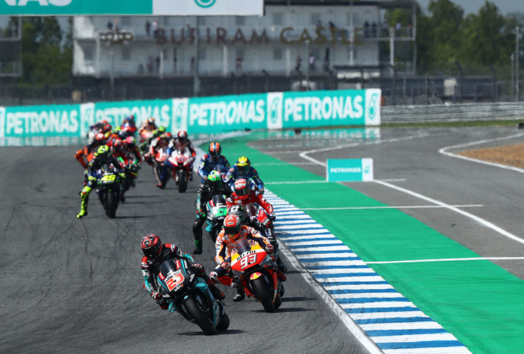 Fabio Quartararo (20) leads Marc Marquez (93) and the rest of the field early in the MotoGP race in Thailand. Photo courtesy of PETRONAS Yamaha SRT.