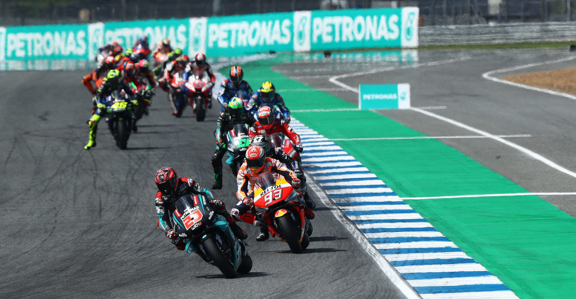 Fabio Quartararo (20) leads Marc Marquez (93) and the rest of the field early in the MotoGP race in Thailand in 2019. Photo courtesy of PETRONAS Yamaha SRT.