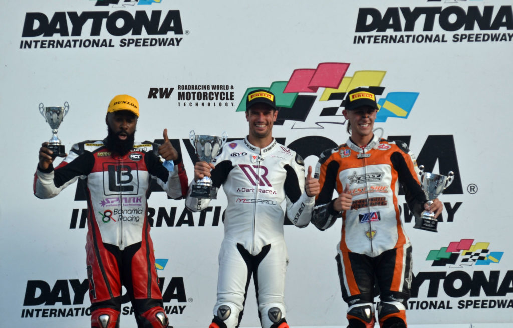 Squid Hunter Racing’s Simone Corsi (center) on the ASRA Team Challenge podium in Daytona International Speedway’s Victory Lane with West Side Performance’s Christian Miranda (right), the runner-up, and LB Sports’ Lloyd Bayley (left), the third-place finisher. Photo by David Swarts.