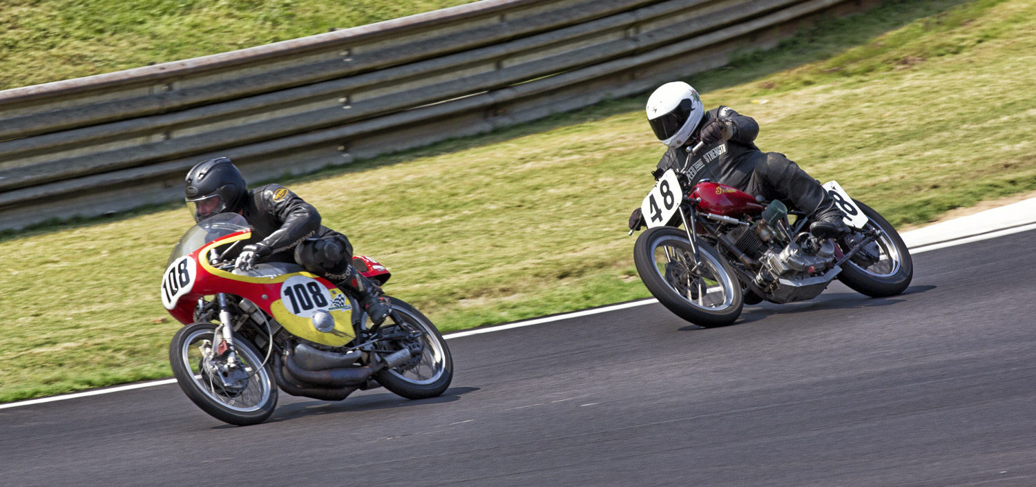 AHRMA racers Paul Piskor (108) and Scott Olofson (48) in action at Barber Motorsports Park. Photo by Kevin McIntosh, courtesy of AHRMA.