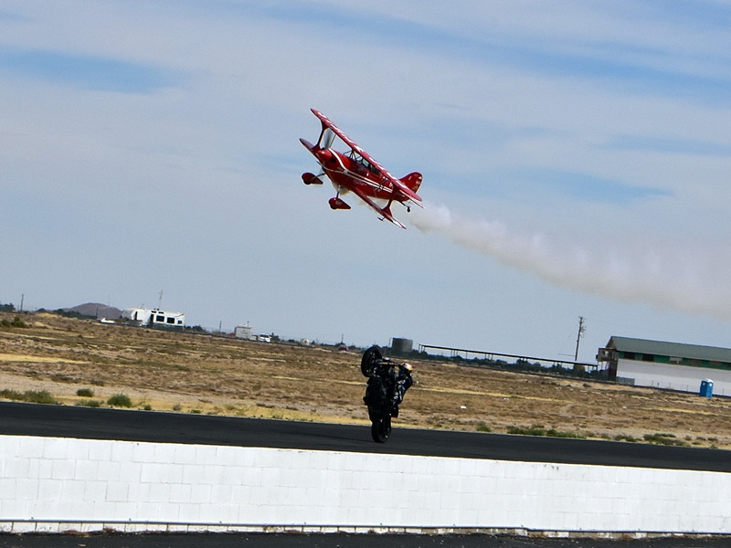 Stunt pilot Anthony Oshinuga and Red Bull freestyler and flat track racer Aaron Colton performing in tandem on the front straight at Willow Springs. Photo by Michael Gougis.