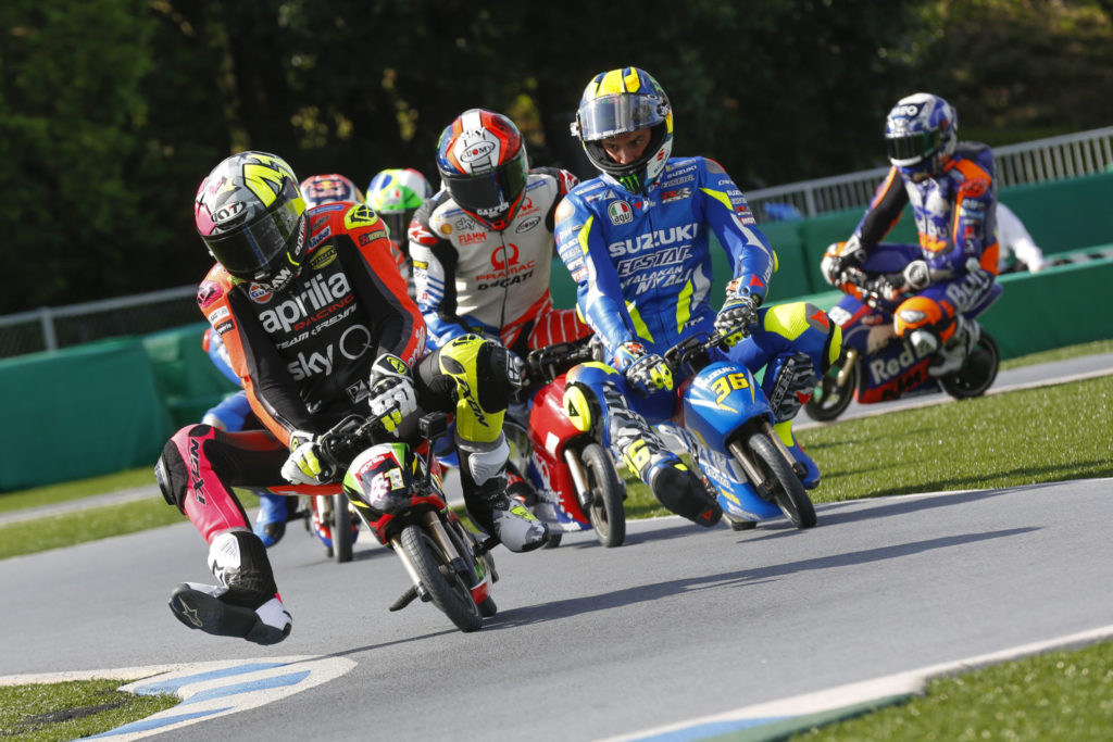 Aleix Espargaro (41) leading Joan Mir (36), Francesco Bagnaia, and the rest during a minibike race at Motegi. Photo courtesy of Dorna/www.motogp.com.