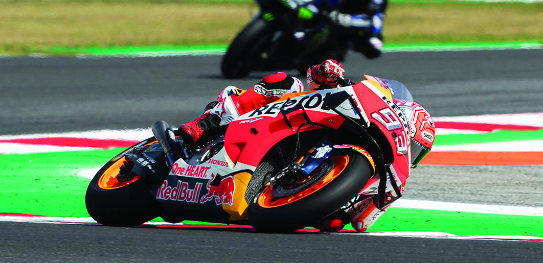 Marc Marquez (93) has just won his eighth World Championship and has found new ways to win when it shouldn’t be possible. He also leans more than anybody else can without crashing! Here, Marquez leads Maverick Viñales and Andrea Dovizioso at Misano. Photo by DPPI Media.