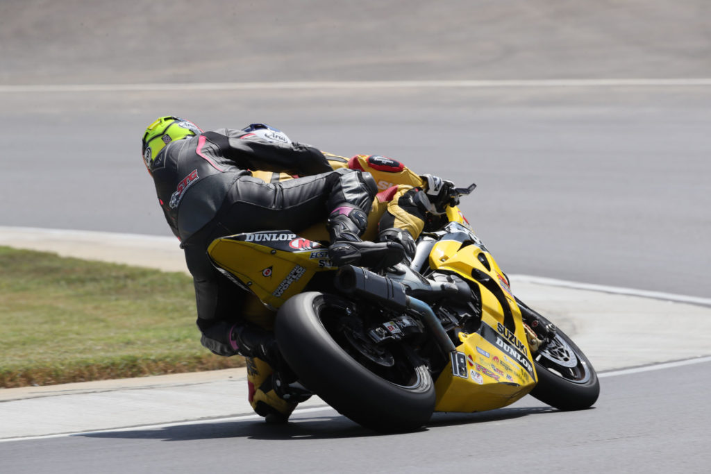 Chris Ulrich (18) giving a ride on his two-seat Dunlop M4 Suzuki GSX-R1000R Superbike at a MotoAmerica event. Photo by Brian J. Nelson.