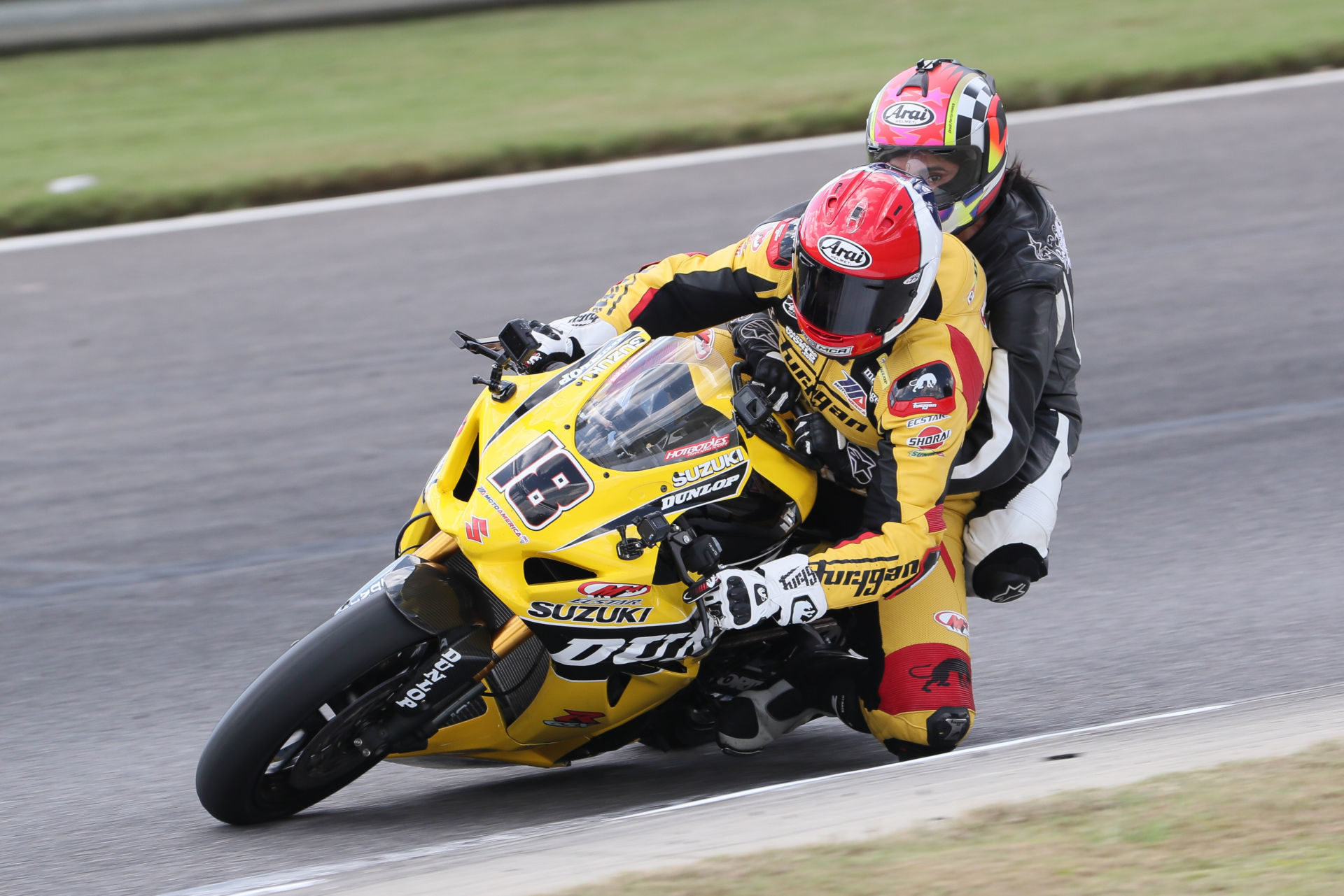 Chris Ulrich (18) giving a ride on his two-seat Dunlop M4 Suzuki GSX-R1000R Superbike at a MotoAmerica event. Photo by Brian J. Nelson.