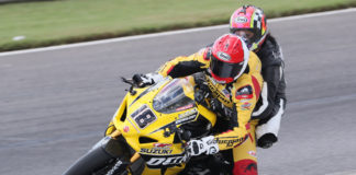 Chris Ulrich (18) giving a ride on his two-seat Dunlop M4 Suzuki GSX-R1000R Superbike at a MotoAmerica event. Photo by Brian J. Nelson.