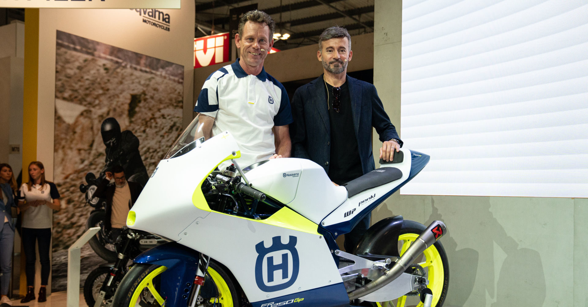 Max Racing Team Manager Peter Öttl (left), Max Racing Team Principal Max Biaggi (right), and a Husqvarna FR 250 GP Moto3 racebike. Photo courtesy of Husqvarna Motorcycles.