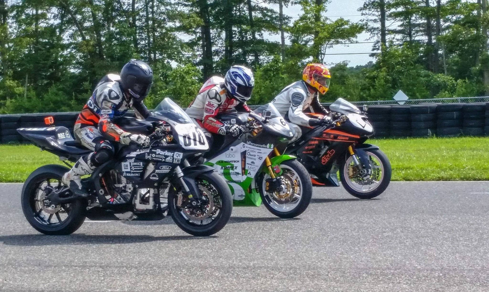 Electric motorcycles as built by students at (from left) Virginia Tech, the University of Sherbrooke in Quebec, and the Rochester Institute of Technology at AHRMA's 2019 Varsity Challenge. Photo courtesy of AHRMA.