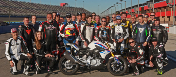 Fastrack Academy V coaches Chris Ulrich, Eric Bostrom, Jake Zemke and Josh Hayes (subbing for Jeremy Toye) and participants with the grand prize, a BMW G 310 R, at Auto Club Speedway. Photo by CaliPhotography.com, courtesy of Fastrack Academy.