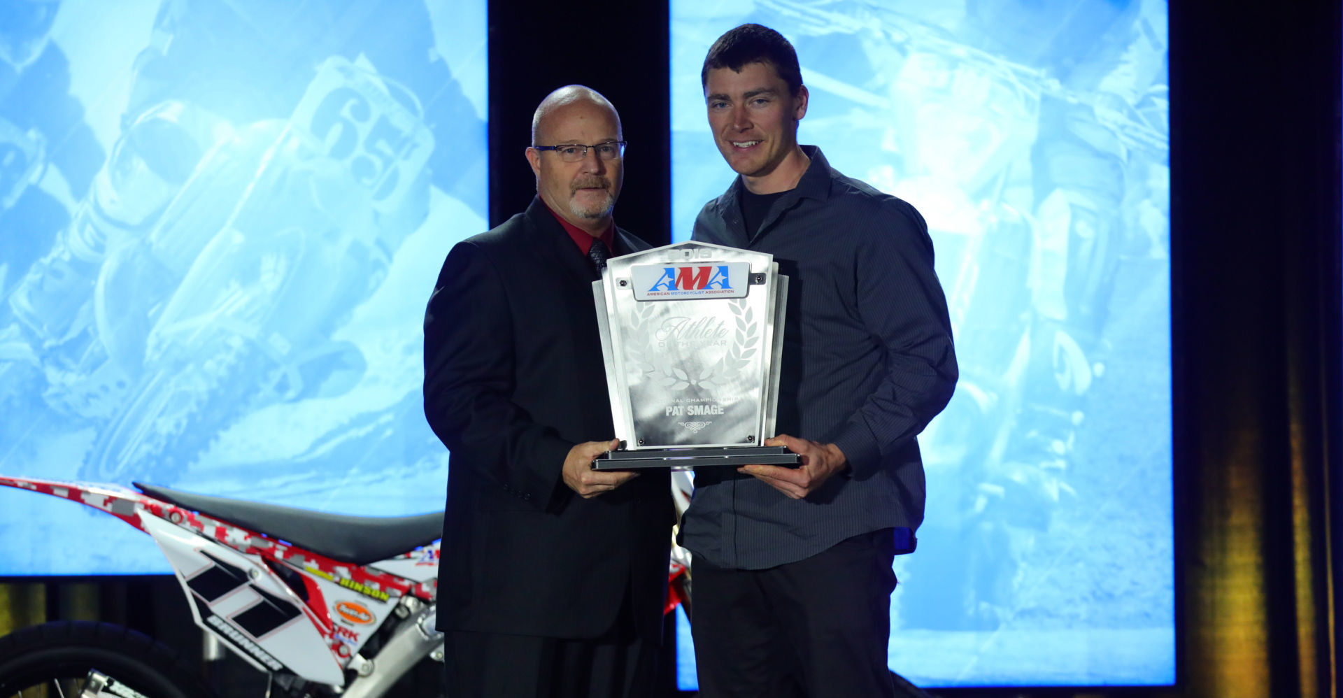 AMA Director of Racing Kevin Crowther (left) presents the 2019 AMA Athlete of the Year from AMA National Championship Series Award to 11-time AMA/NATC MotoTrials Pro Class National Champion Pat Smage at the 2019 KTM AMA Championship Banquet. Photo by Jeff Kardas, courtesy of AMA.