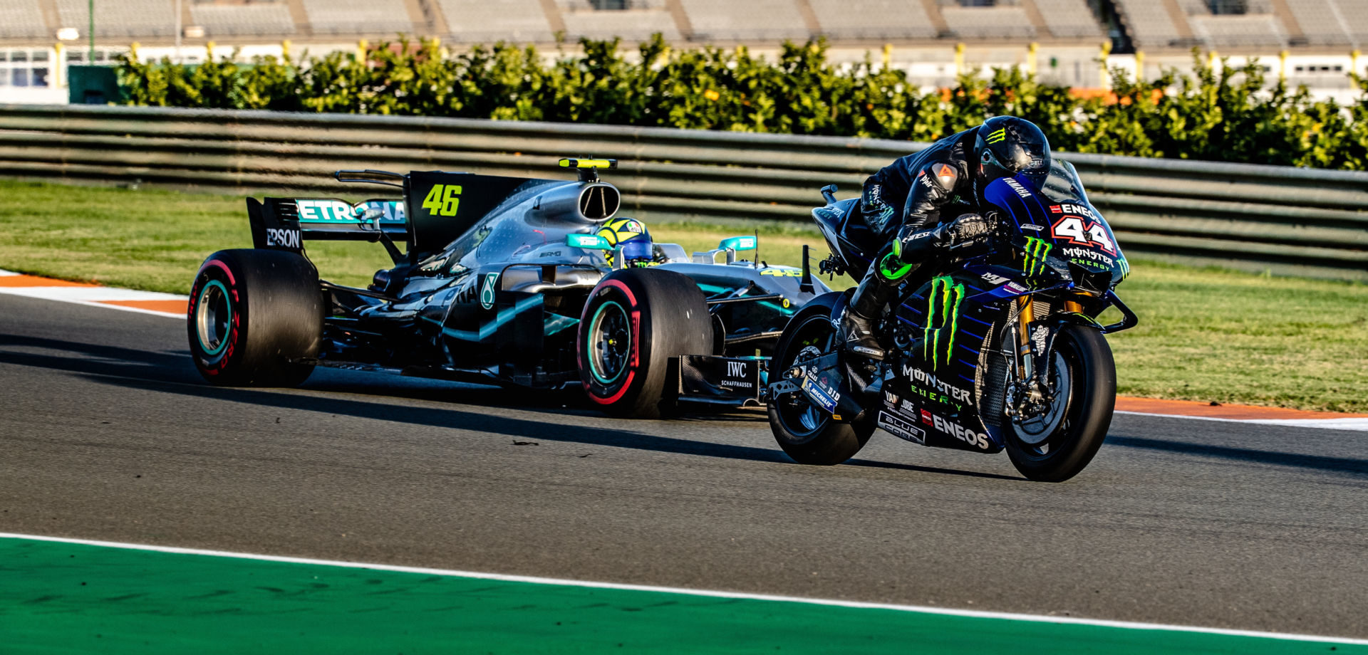 Formula One race car driver Lewis Hamilton (44) on a Monster Energy Yamaha YZR-M1 MotoGP racebike and MotoGP racer Valentino Rossi (46) in a Mercedes-AMG F1 W08 EQ Power+ Formula One race car at Valencia. Photo courtesy of Monster Energy Yamaha.