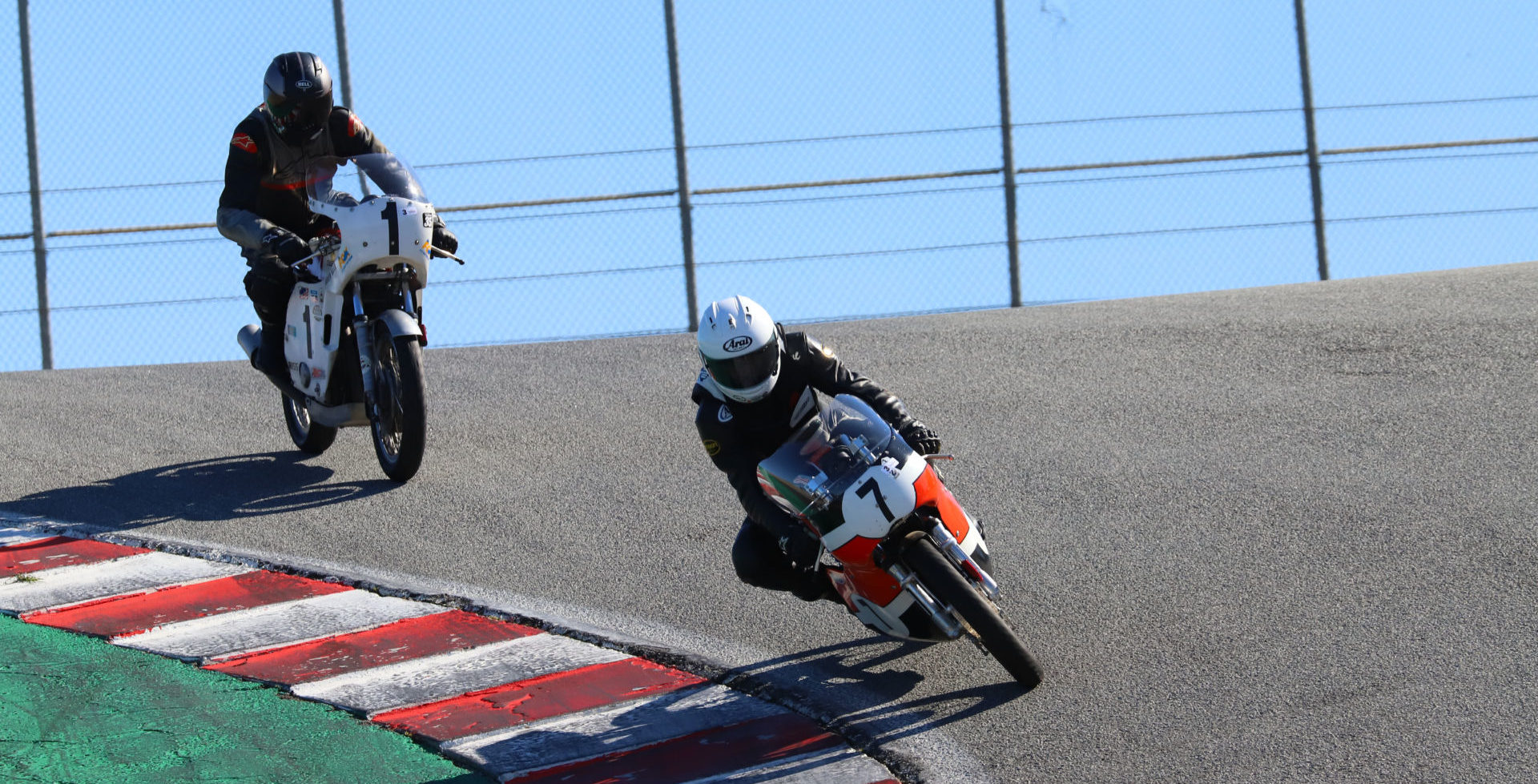 Dave Roper (7) leads Andrew Mauk (1) down the Corkscrew at WeatherTech Raceway Laguna Seca on his way to victory in AHRMA Vintage Cup Round Two. Photo by etechphoto.com, courtesy of AHRMA.