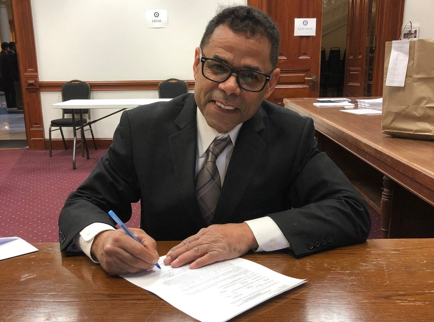 Caesar Gonzales signing the paperwork to seek election to the U.S. Congress. Photo courtesy of Caesar Gonzales.