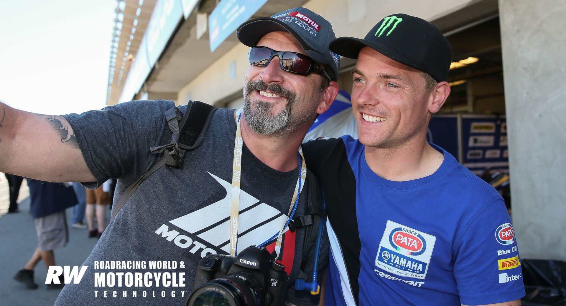 Matt Greenstone (left) taking a photo with World Superbike racer Alex Lowes at Laguna Seca Raceway in 2016. Photo by David Swarts.