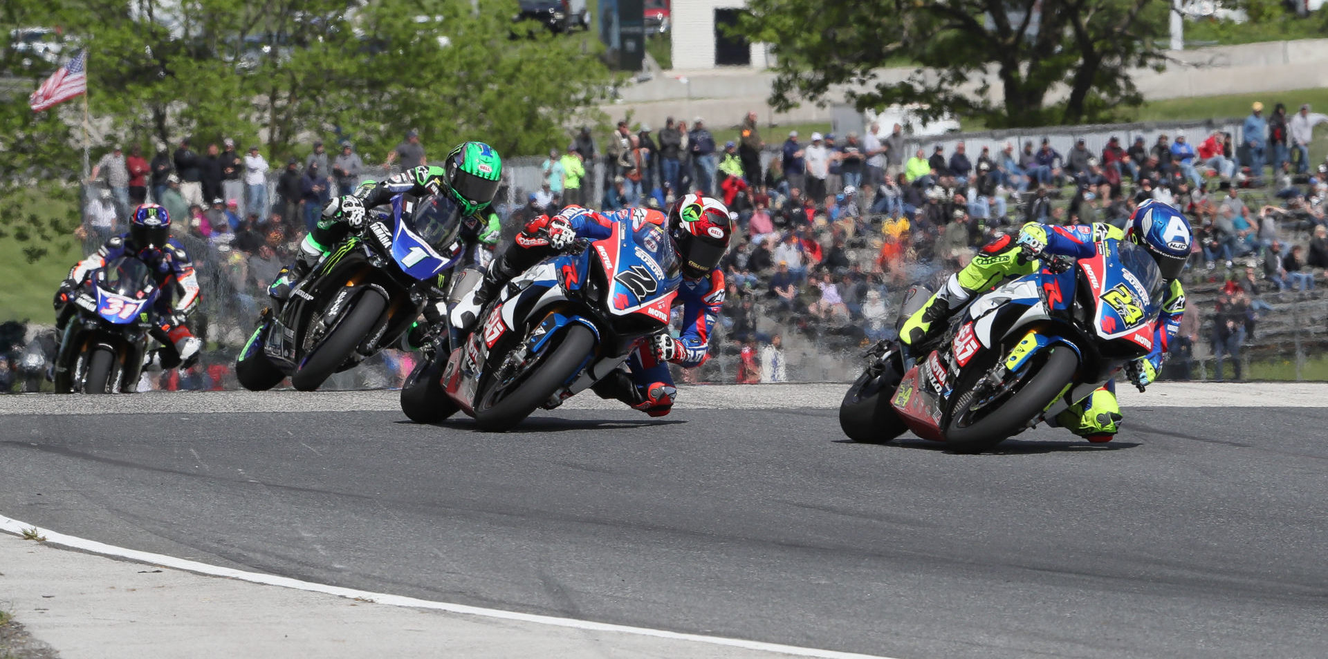 Toni Elias (24), Josh Herrin (2), Cameron Beaubier (1), and Garrett Gerloff (31) battle in front of fans at Road America in 2019. Photo by Brian J. Nelson.