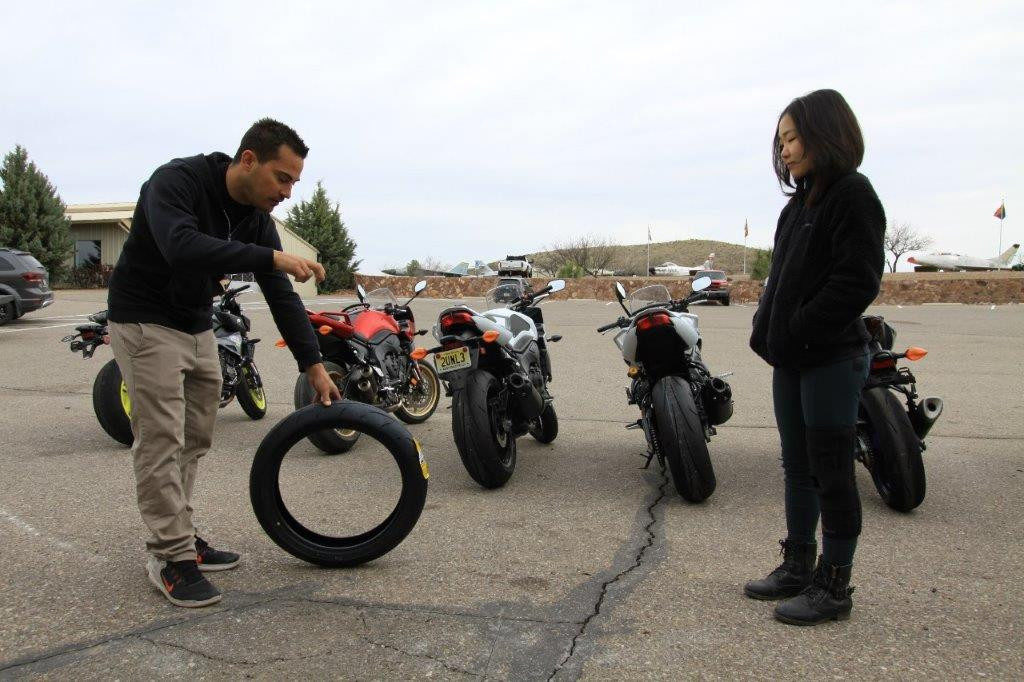 Yamaha Champions Riding School instructor and Army of Darkness rider Chris Peris (left) explains to Hiyori Yoshida how trail-braking, or turning, loads the front tire and increases the contact patch. 