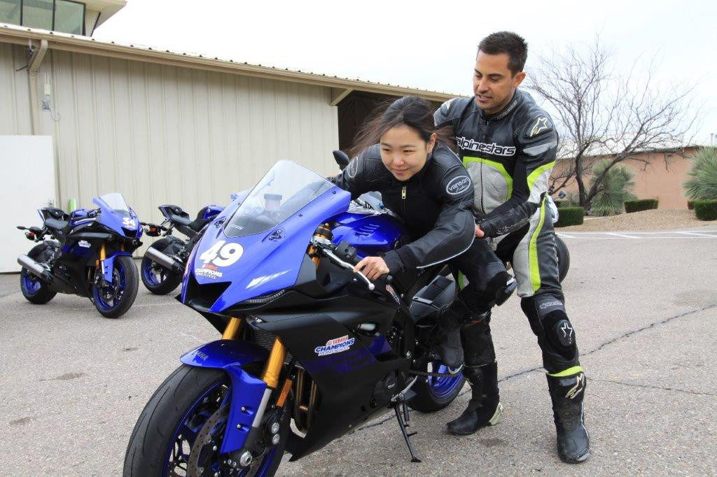 Yamaha Champions Riding School instructor and Army of Darkness rider Chris Peris teaching Hiyori Yoshida proper sportbike riding body positioning. After years of learning to be positioned on the high side of the seat for dirt riding, it was a bit of an adjustment to be on the low side of the seat. 