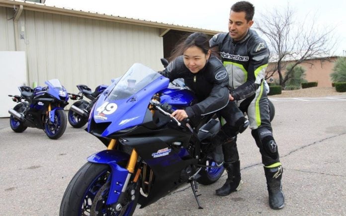 Yamaha Champions Riding School instructor and Army of Darkness rider Chris Peris teaching Hiyori Yoshida proper sportbike riding body positioning.