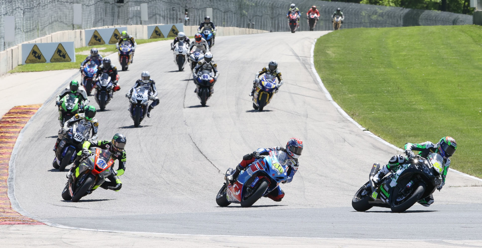 Richie Escalante (54) leads Sean Dylan Kelly (40), Brandon Paasch (21), and the rest of the field during MotoAmerica Supersport Race Two at Road America. Photo by Brian J. Nelson, courtesy MotoAmerica.