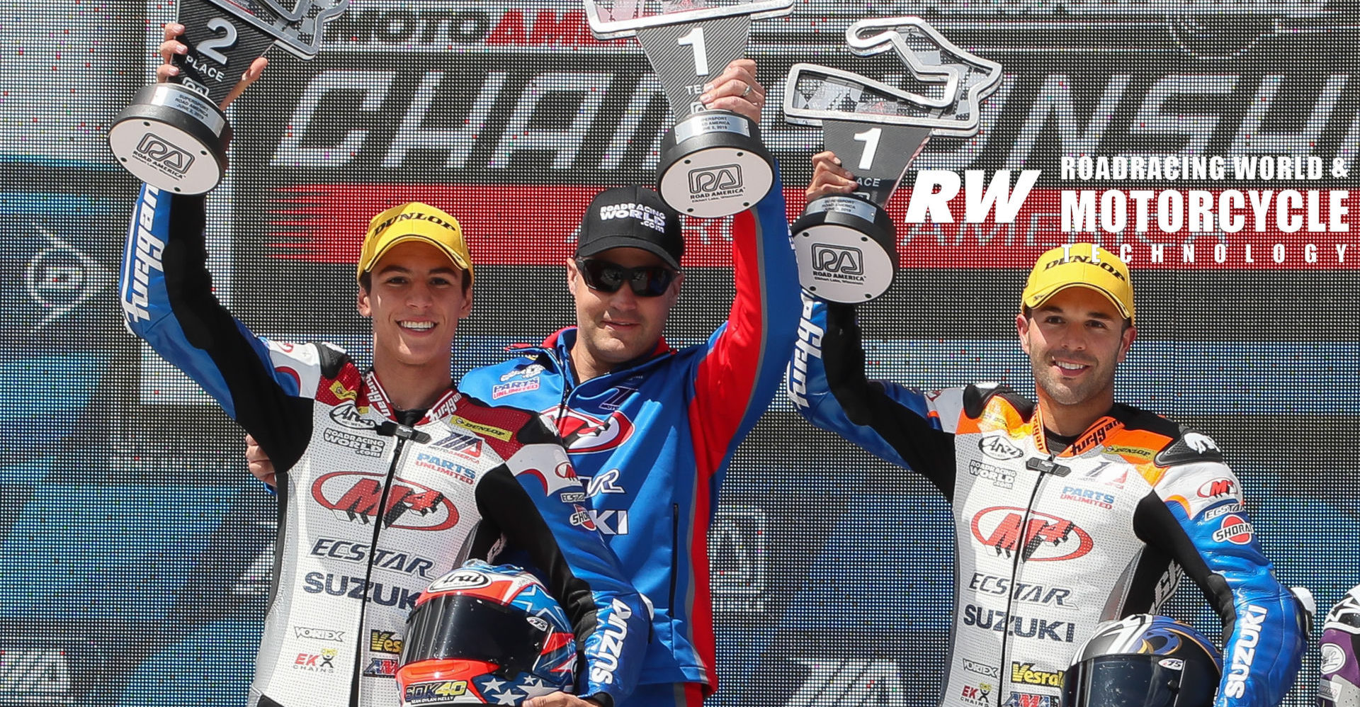 Chris Ulrich (center) on the podium with his riders Bobby Fong (right) and Sean Dylan Kelly (left), after Fong won and Kelly finished second in MotoAmerica Supersport Race Two at Road America in 2019. Photo by Brian J. Nelson.