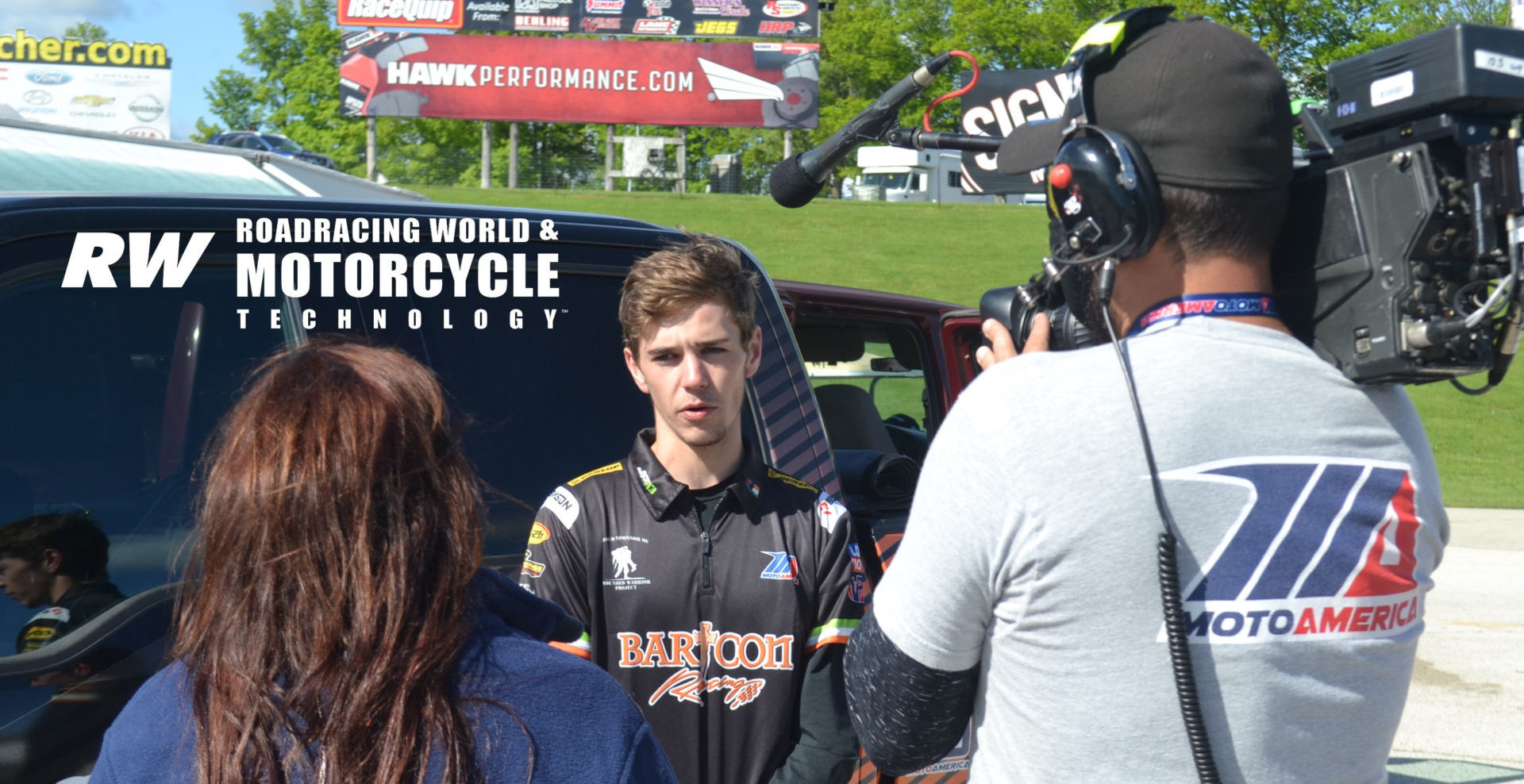 MotoAmerica Junior Cup racer and recent high school graduate Dominic Doyle getting interviewed by a camera crew after breaking the lap record and securing pole position for his races at Road America. Photo by David Swarts.