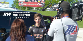MotoAmerica Junior Cup racer and recent high school graduate Dominic Doyle getting interviewed by a camera crew after breaking the lap record and securing pole position for his races at Road America. Photo by David Swarts.
