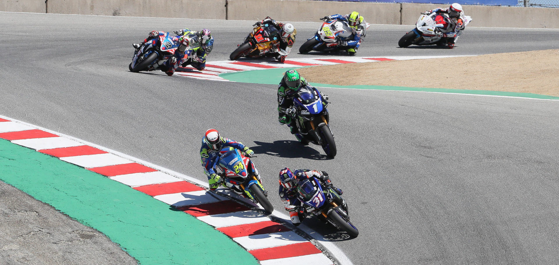 Garrett Gerloff (31) leads Toni Elias (24), Cameron Beaubier (1) and the rest of the MotoAmerica Superbike field at WeatherTech Raceway Laguna Seca in 2019. Photo by Brian J. Nelson.