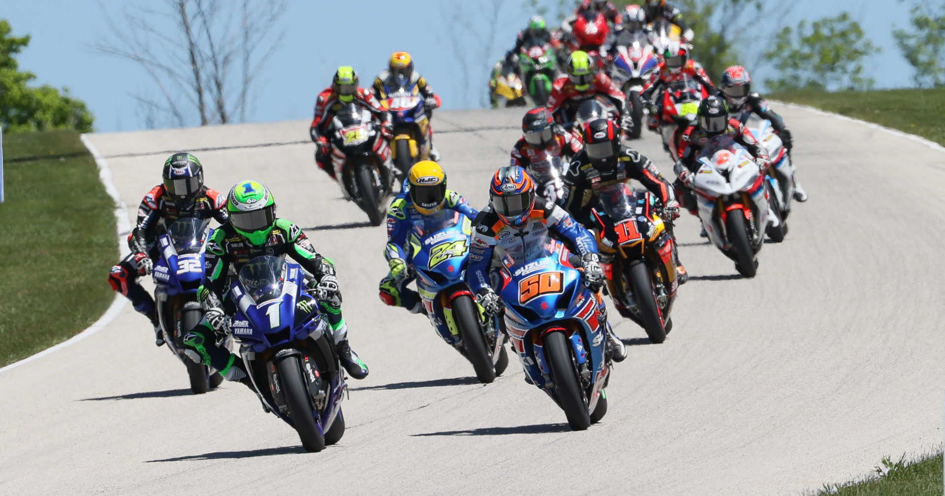 Cameron Beaubier (1) passes Bobby Fong (50) for the lead early in MotoAmerica HONOS Superbike Race Two at Road America. Photo by Brian J. Nelson, courtesy MotoAmerica.