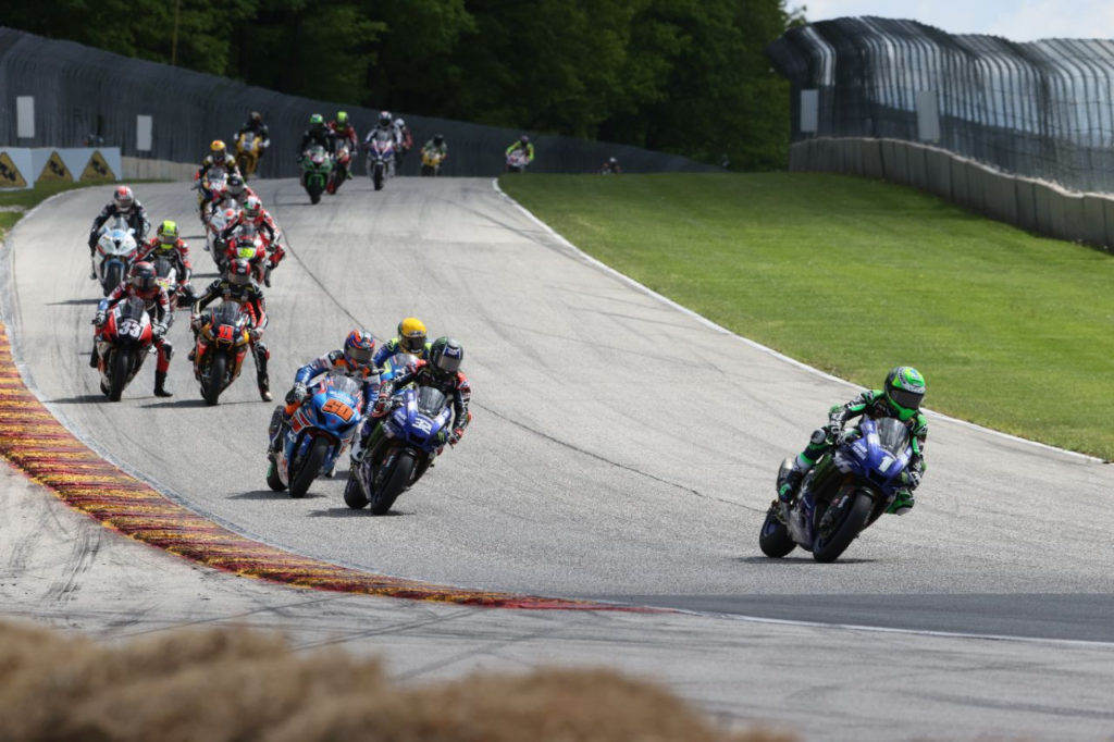 Cameron Beaubier (1) leads Jake Gagne (32), Bobby Fong (50), Toni Elias (behind Gagne), Mathew Scholtz (11), Kyle Wyman (33), and the rest of the MotoAmerica HONOS Superbike field early in Race One at Road America. Photo courtesy of Yamaha.