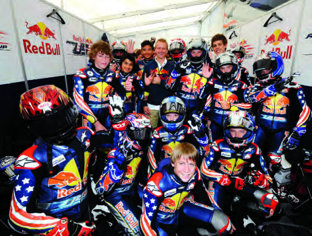 Kevin Schwantz poses with the Red Bull AMA Rookies Cup kids at Mazda Raceway Laguna Seca, 2008. Photo by DPPI Media.