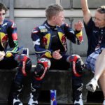 Kevin Schwantz (right) working with Red Bull MotoGP Rookies Cup riders Taylor Mackenzie (center) and Mathew Scholtz (left) at Brno in 2010. Photo by Gold& Goose/GEPA Pictures, courtesy Red Bull.
