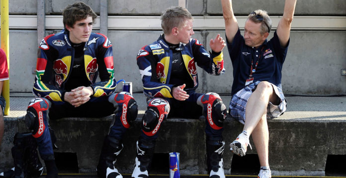 Kevin Schwantz (right) working with Red Bull MotoGP Rookies Cup riders Taylor Mackenzie (center) and Mathew Scholtz (left) at Brno in 2010. Photo by Gold& Goose/GEPA Pictures, courtesy Red Bull. Kevin Schwantz (right) working with Red Bull MotoGP Rookies Cup riders Taylor Mackenzie (center) and Mathew Scholtz (left) at Brno in 2010. Photo by Gold& Goose/GEPA Pictures, courtesy Red Bull.