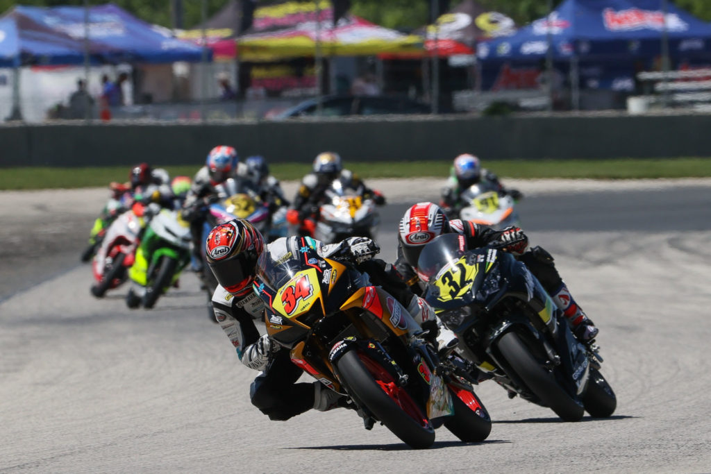 Cody Wyman (34) leads a group of riders during MotoAmerica Junior Cup Race One at Road America 2. Photo by Brian J. Nelson, courtesy Westby Racing.