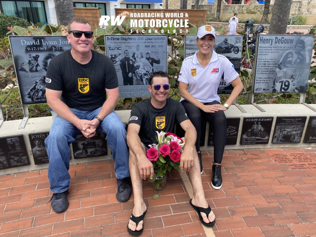 TOBC Racing owner Michelle Lindsay (right) with Crew Chief Scott Harwell (left) and rider Danny Eslick (center) with the plaque honoring their three Daytona 200 victories together. Photo by Joan Erdesky, courtesy TOBC Racing.