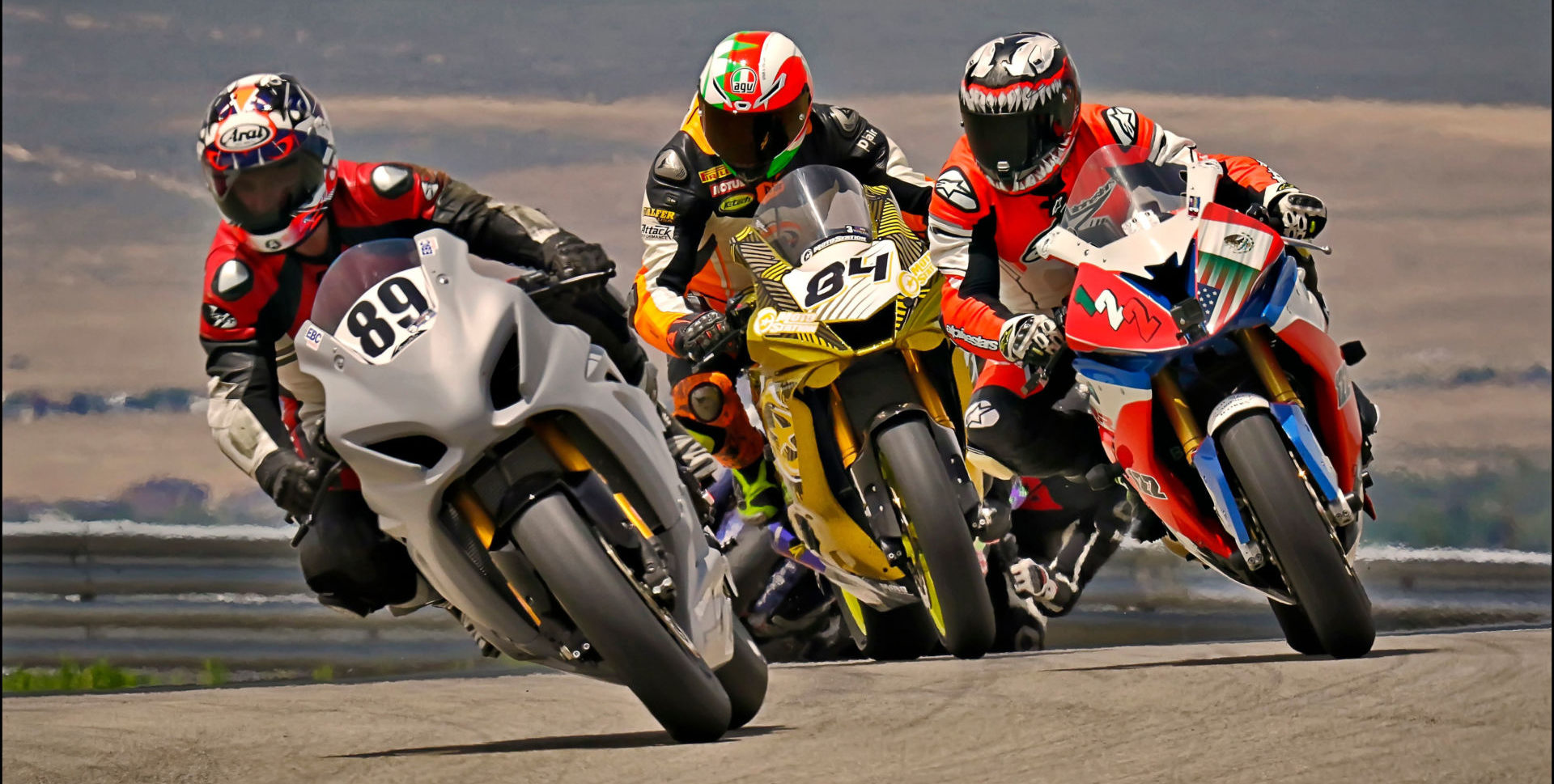 Adam Robarts (89) leads ahead of Kory Cowan (84) and Genaro Lopez (122) on the first lap of the Utah Motorcycle Law Master's of the Mountains Race June 20 at Utah Motorsports Campus. Photo by Steve Midgley, courtesy UtahSBA.