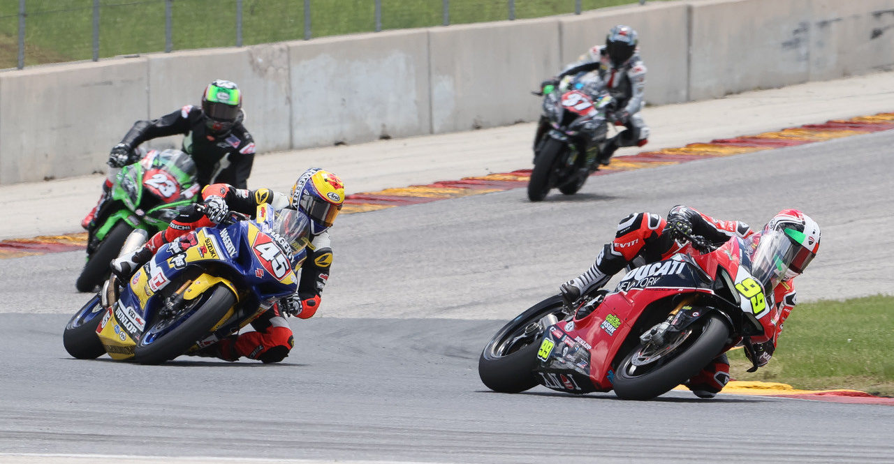 PJ Jacobsen (99), riding a Ducati Panigale V4 R, leads Cameron Petersen (45), Corey Alexander (23), and Stefano Mesa (37) during the MotoAmerica Stock 1000 race at Road America. Photo by Brian J. Nelson, courtesy MotoAmerica.