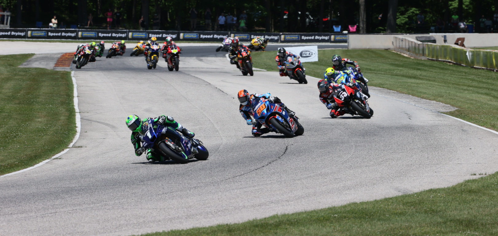 Cameron Beaubier (1) leads Bobby Fong (50), Kyle Wyman (33), Toni Elias (24), Jake Gagne (32), Josh Herrin (2), Mathew Scholtz (11), and the rest of the field early in MotoAmerica Superbike One. Photo by Brian J. Nelson, courtesy MotoAmerica.