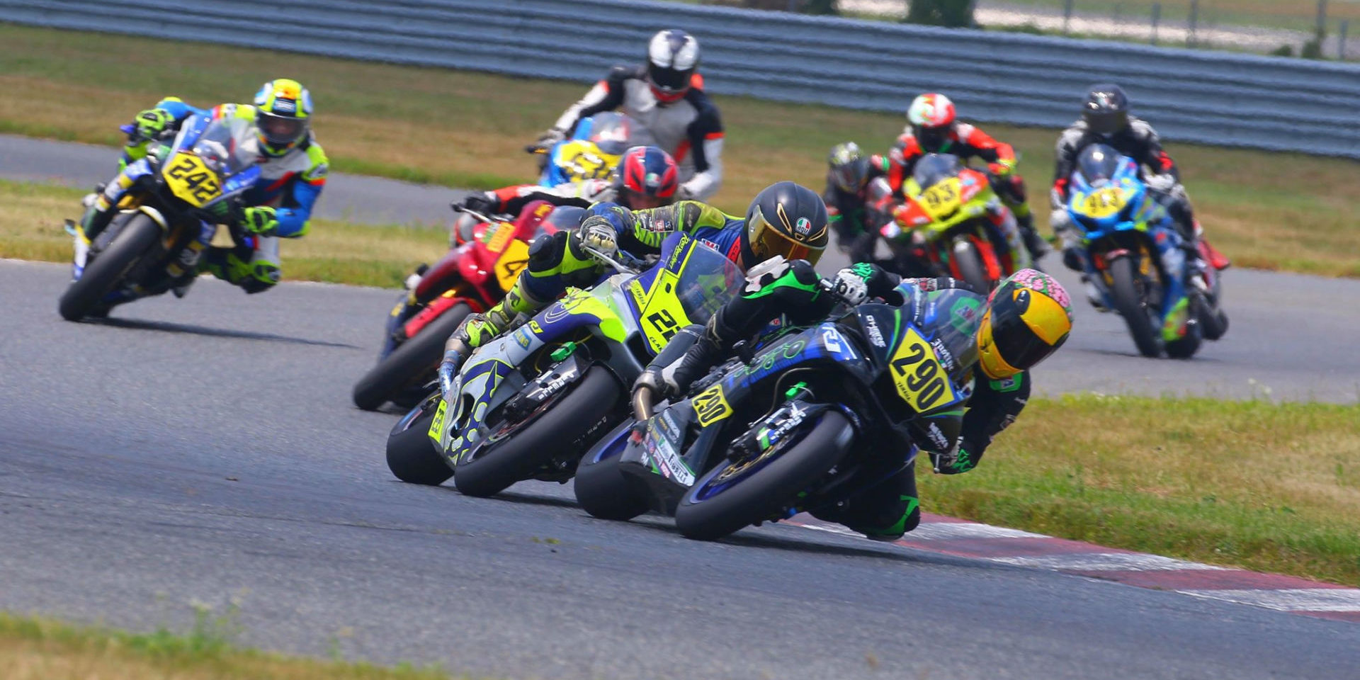 Justine Miraglia (290) leading the MotoGirlGT Superbike race and making her way through the Heavyweight Supersport Amateur field at New Jersey Motorsports Park. Photo by etechphoto.com, courtesy MotoGirlGT.