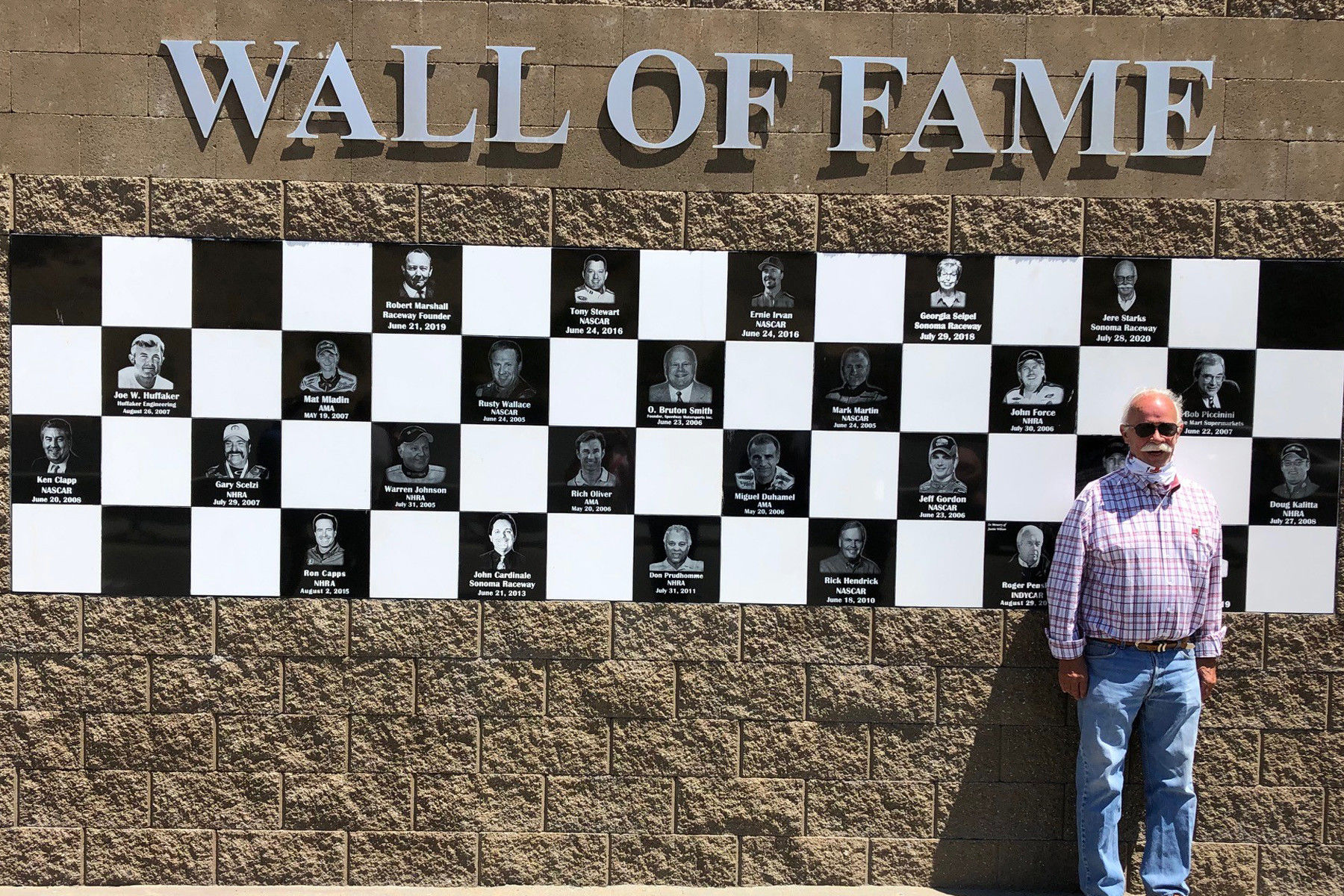 Jere Starks in front of the Wall of Fame at Sonoma Raceway. Photo courtesy Sonoma Raceway.