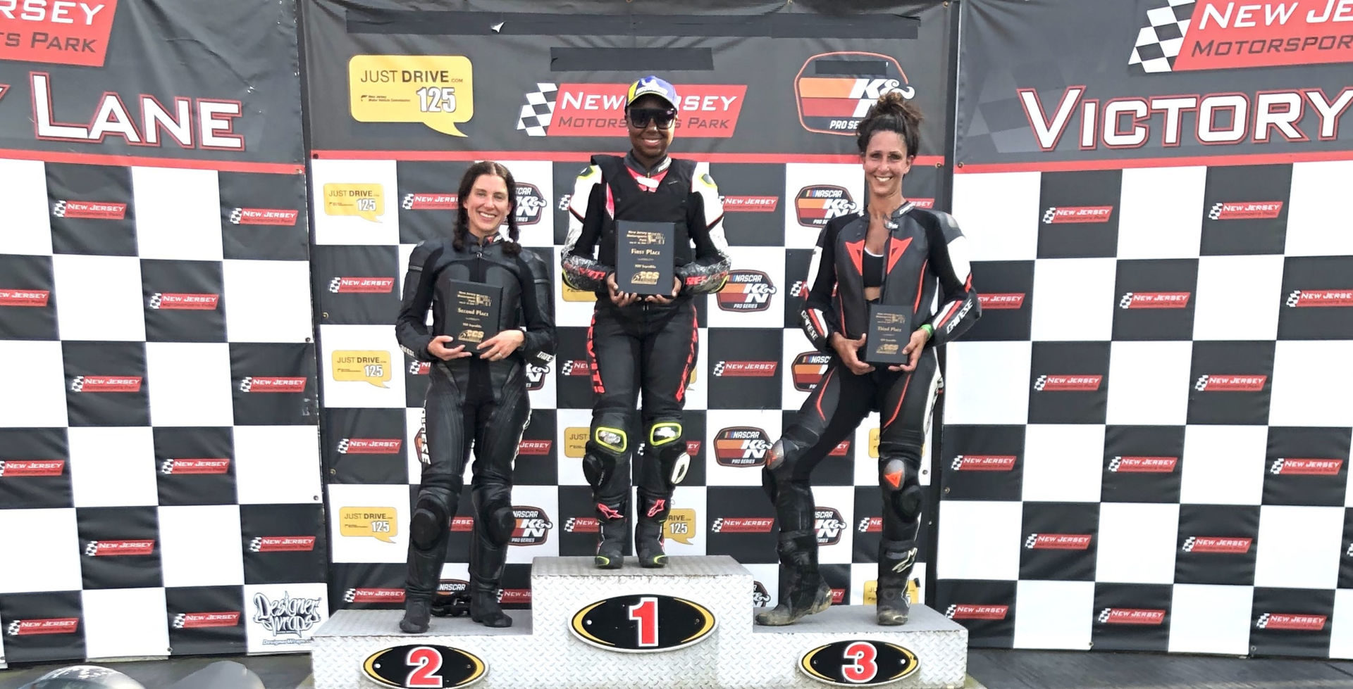 MotoGirlGT 500 Superbike race winner Mikayla Moore (center), runner-up Cassie Cuppek (left), and third-place finisher Michele Beneducci (right). Photo by Angela Izzo-Sink, courtesy MotoGirlGT.