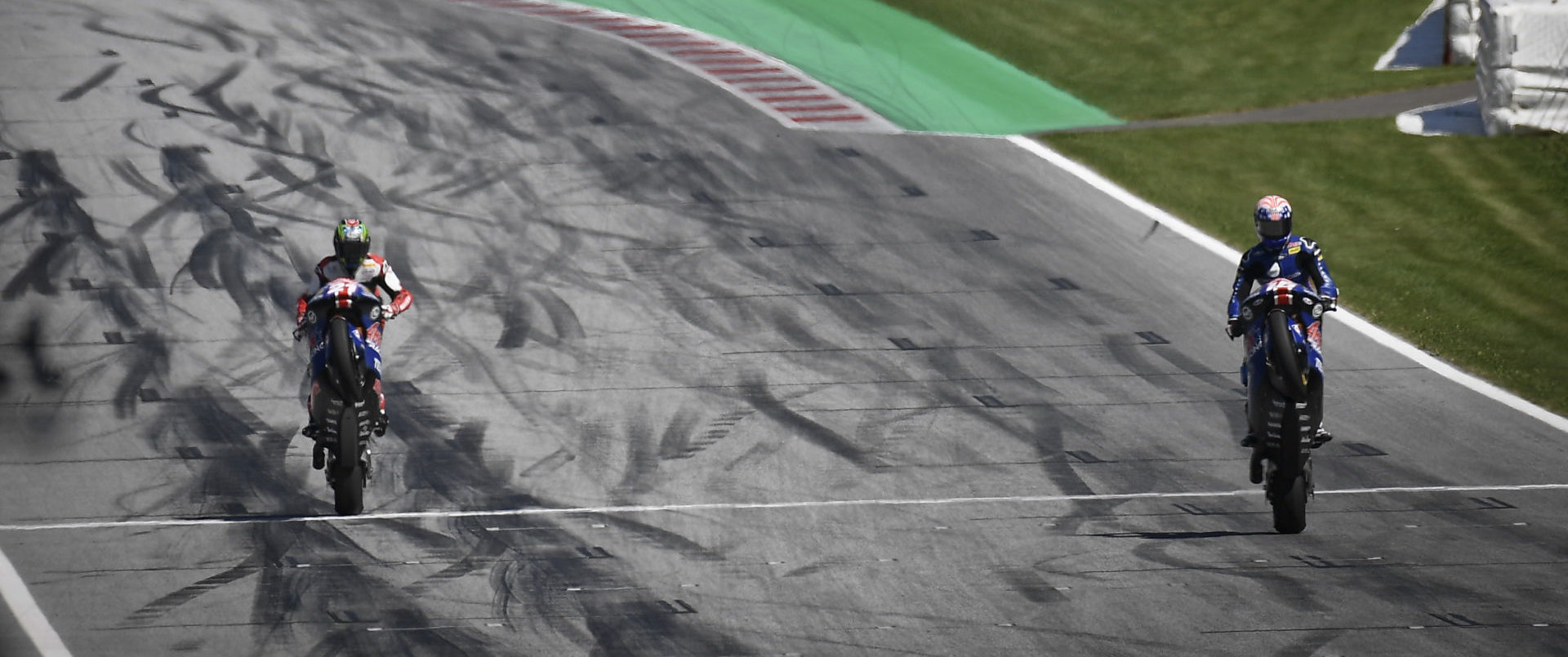 John Hopkins (left) celebrates the 20th anniversary of his first ride on a MotoGP racebike by going for a ride around the Red Bull Ring with his protégé Joe Roberts (right). Photo courtesy Dorna.