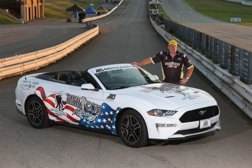 Colin Barton with his Mustang convertible, flying the BARTCON Racing and Wounded Warrior livery. Photo by Brian J. Nelson.