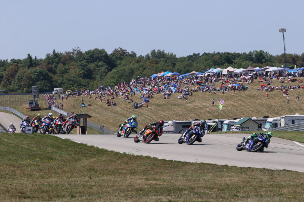 Cameron Beaubier (1) leads Jake Gagne (32), Mathew Scholtz (11), Toni Elias (24) and the rest of the field at the start of MotoAmerica HONOS Superbike Race Two at PittRace. Photo by Brian J. Nelson, courtesy MotoAmerica.