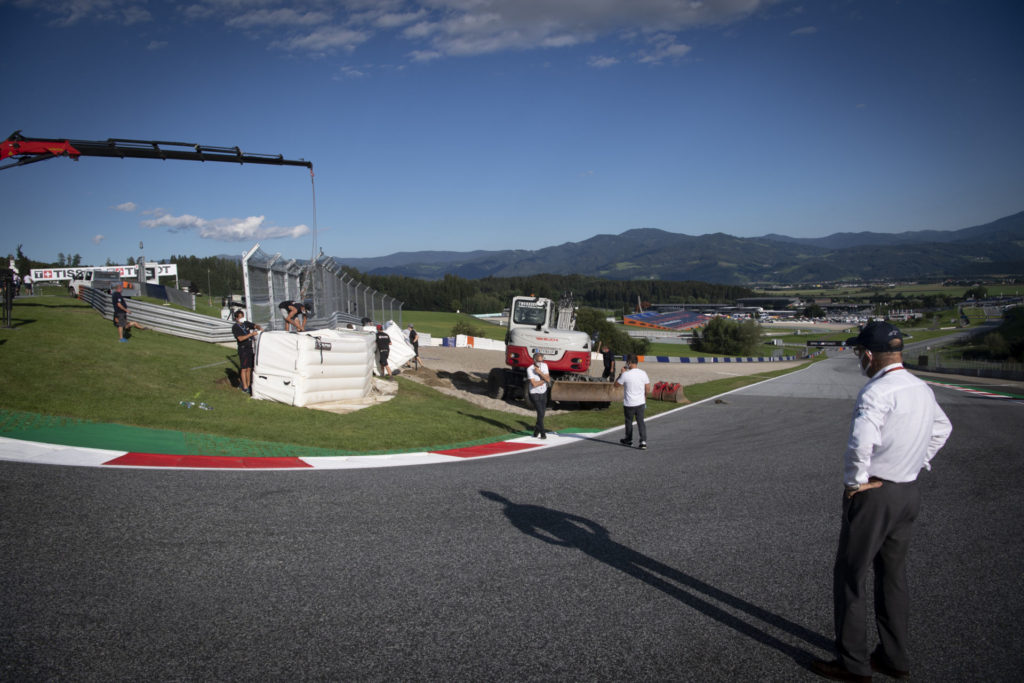 Dorna CEO Carmelo Ezpeleta (right) looks on as modifications are made to Turn Three at the Red Bull Ring. Photo courtesy Dorna.