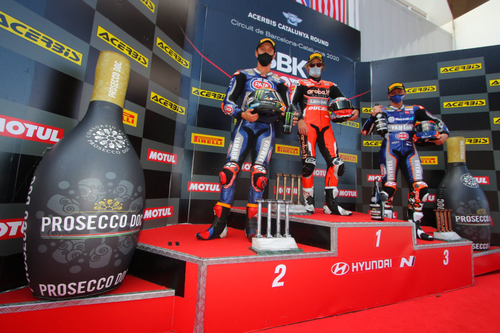 Race Two winner Chaz Davies (center)  flanked by second place Michael van der Mark (left)  and third place Garrett Gerloff (right). Photo courtesy Dorna.