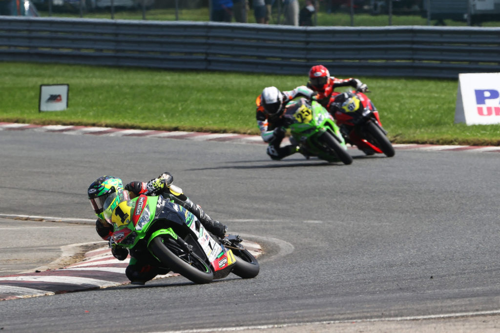 Defending Champion Rocco Landers (1) won both Junior Cup races at New Jersey Motorsports Park. Here, he leads South African immigrants Dominic Doyle (25) and Sam Lochoff (57) on Saturday. Landers doubled down on racing with MotoAmerica when European countries enacted Covid-19 related travel restrictions, putting the Red Bull MotoGP Rookies Cup season in question. Photo by Brian J. Nelson.
