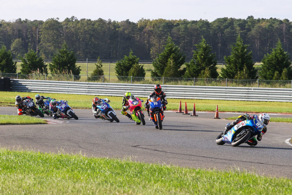 Rocco Landers (97) is doing double duty at MotoAmerica events, winning in both Junior Cup (on a Kawasaki Ninja 400) and in Twins Cup races (on a Suzuki SV650). Here, Landers leads the first Twins Cup race on a SportbikeTrackGear.com SV650, chased by Teagg Hobbs (79), on another Suzuki SV650; Kaleb De Keyrel (51) on a Yamaha MT-07; Dominic Doyle (25), Jackson Blackmon (18), and Toby Khamsouk (27) on SV650s; and Hayden Schultz on a Yamaha MT-07. Photo by Brian J. Nelson.