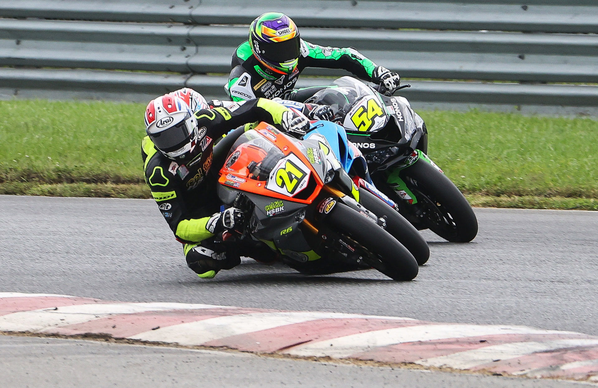 New Jersey's own Brandon Paasch (21) stuffs it under Sean Dylan Kelly (40) who was already under Richie Escalante (54) in Supersport Race Two, one of the best Supersport battles seen in decades. Photo by Brian J. Nelson.
