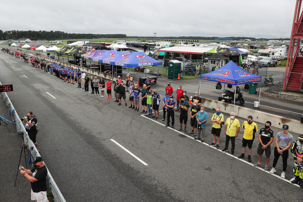 Race team members lining up on the front straightaway at New Jersey Motorsports Park on Friday morning of the race weekend, September 11th, remembering the Americans killed on the 19th anniversary of the terrorist attacks known as 9/11. Photo by Brian J. Nelson.