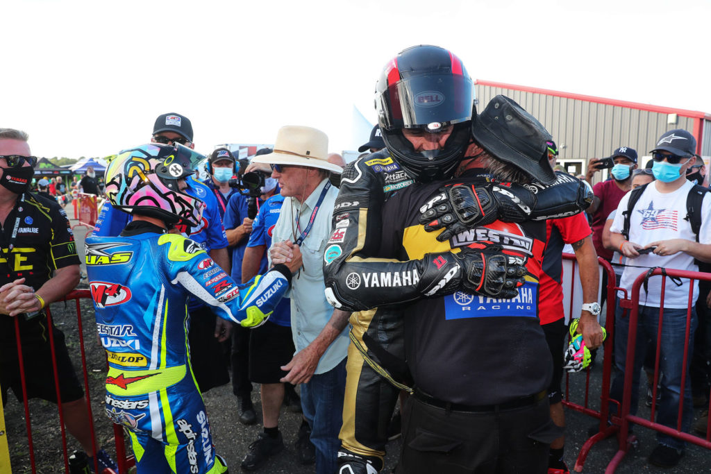 Rider Mathew Scholtz hugs Westby Racing team owner Tryg Westby after finishing second in the Saturday Superbike race. Photo by Brian J. Nelson.